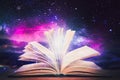 Open book with glitter overlay and beautiful universe on background