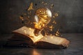 Open Book With Glowing Light Bulb Inside With Brain Shape And Gears Art Inside On Dark Background Royalty Free Stock Photo