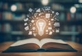 Open book with graduation cap and light bulb, education knowledge concept Royalty Free Stock Photo