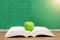 Open book with green apple in concept education. Royalty Free Stock Photo