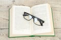 Open book, hardback books, glasses on wooden table. Back to school. Education. Copy space for text Royalty Free Stock Photo