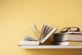 Open book, hardback books on wooden shelf. Education background. Back to school. Copy space for text.