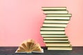 Open book, hardback books on wooden table, on a pink background. Back to school. Copy space for text. Education background Royalty Free Stock Photo