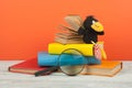 Open book, hardback colorful books on wooden table. Magnifier, toy crow. Back to school. Copy space for text. Education Royalty Free Stock Photo