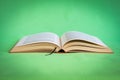 Open book with hardcover on green background, clipping path Royalty Free Stock Photo