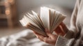 The open book held gently in hands, inviting readers to explore its pages. AI generated image Royalty Free Stock Photo