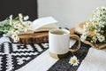 Open book, herbal chamomile tea cup on wooden table, reading and morning relax concept Royalty Free Stock Photo