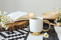 Open book, herbal chamomile tea cup on wooden table, reading and morning relax concept Royalty Free Stock Photo