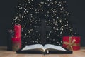 The open book of the Holy Bible. Gift. Christmas tree. Cross. The birth of Jesus is a manifestation of love for people. Agape