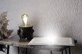 Open book Holy Bible on the table. Loft style lamp. In room. Desktop. Office.