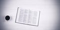 An open book of the Holy Bible on the table. Scripture. A cup of coffee on the table. On a white Royalty Free Stock Photo