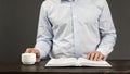 The open book is the holy bible. Young man in a shirt. Prayer and Scripture Reading Royalty Free Stock Photo