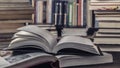 Open Book In Library full of stacks of books.