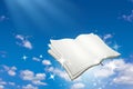 Open book with magic sparkle flying on blue sky background. Reading and Writing concept Royalty Free Stock Photo