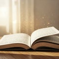 An open book with a magical glow against the background of the window. Royalty Free Stock Photo