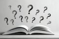 Open book with multiple question marks floating above symbolizing curiosity doubt and the quest for knowledge or answers in black Royalty Free Stock Photo