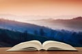 Open book over the landscape background Royalty Free Stock Photo