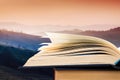 Open book over the landscape background Royalty Free Stock Photo