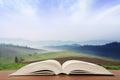 Open book over the landscape background Royalty Free Stock Photo