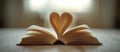 Open Book with Pages Artfully Folded into a Heart Shape, Bathed in Soft Light, Symbolizing Love for Reading and Knowledge Royalty Free Stock Photo