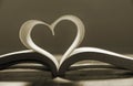 Open book with pages forming heart shape . Royalty Free Stock Photo