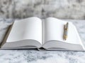 Open Book with Pen on a Marble Table - A Blank Canvas for Thoughts and Ideas Royalty Free Stock Photo