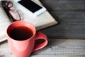 Open book with phone, glasses and coffee or tea top view on table Royalty Free Stock Photo