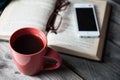 Open book with phone, glasses and coffee or tea top view on table Royalty Free Stock Photo