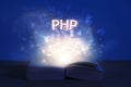 Open book with php inscription. Light coming from open book with word php. Learn programming language Royalty Free Stock Photo