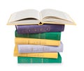 Open book on a pile of vintage books in multicolored covers Royalty Free Stock Photo