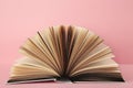 Open book on pink background. Space for text Royalty Free Stock Photo