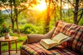 Open book rests on patio couch at sunset Royalty Free Stock Photo
