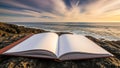 Open book on rocky shore with ocean sunset background Royalty Free Stock Photo