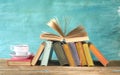 Open book on a row of old books and a cup of coffee. Reading, learning, education, literature Royalty Free Stock Photo