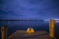 Open book at a sea port at night with a nightlight. Concept: Leasure night reading at the beach Royalty Free Stock Photo