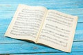 Open book, Sheet Music. Musical Notes on a white wooden table. Background. Royalty Free Stock Photo