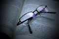 A open book in spanish with glasses