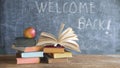 Open book and stack of books with chalk board and red apple.Back to school after corona lockdown Royalty Free Stock Photo