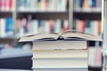 Open book on a stack of books in a library Royalty Free Stock Photo