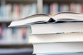 Open book on a stack of books on a table