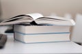 Open book on a stack of books on a table Royalty Free Stock Photo