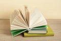 Open book on stack of books on wooden table. Education background. Back to school.