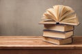 Open book and stack of old books on wooden table Royalty Free Stock Photo