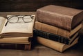 open book on a stack of vintage hardback books on table. concept of education, reading, Generative AI