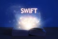 Open book with SWIFT inscription. Light coming from open book with words swift. Learn swift programming language