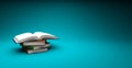 Open book on top of a textbooks heap isolated on blue backdrop with space for text and images Royalty Free Stock Photo