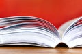 Open book with visible pages against red background Royalty Free Stock Photo