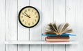 The open book on a wooden shelf and watches.