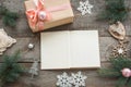 Open book for you Christmas wishes. Preparation for Christmas holiday. Still life. Christmas gift box with pink ribbon and around. Royalty Free Stock Photo