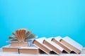 Open books, hardback colorful books on wooden table. blue background. Back to school. Copy space for text. Education business Royalty Free Stock Photo